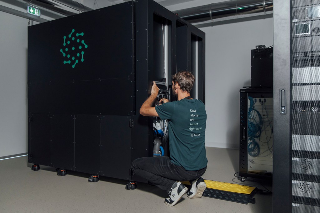 An engineer working on a Pasqal quantum processing unit installed in a high-performance computing facility.